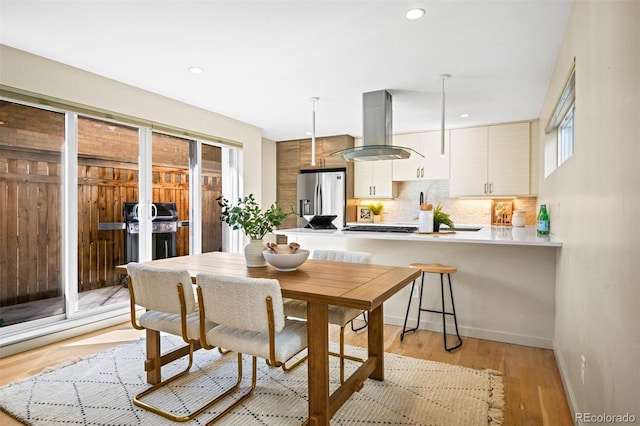1415 Irving St, Denver, CO 80204 - dining space with light wood finished floors, recessed lighting, and baseboards