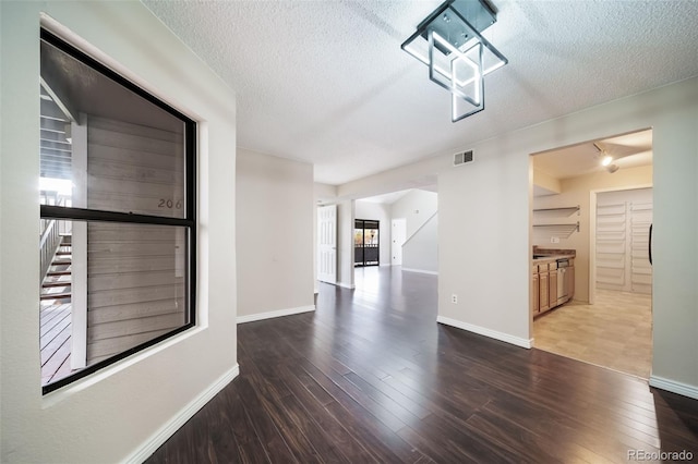 interior space featuring hardwood / wood-style flooring and a textured ceiling