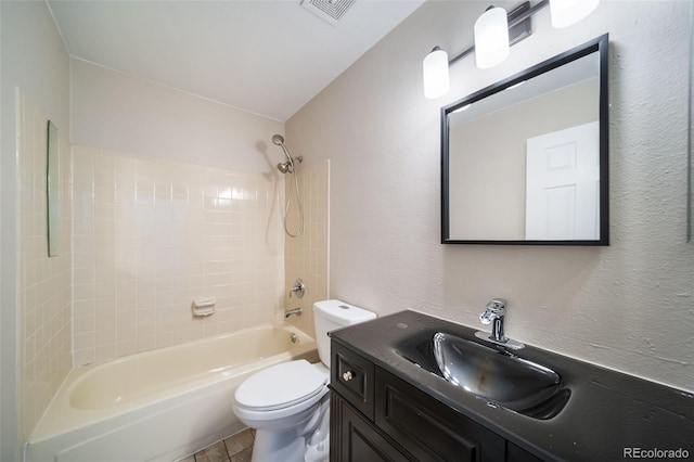 full bathroom with vanity, tiled shower / bath combo, and toilet