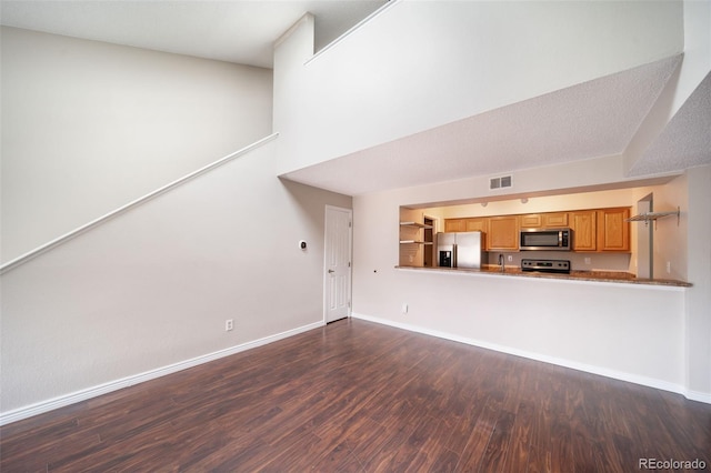 unfurnished living room featuring dark hardwood / wood-style floors