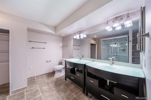 bathroom with vanity, tile patterned flooring, a shower with door, and toilet