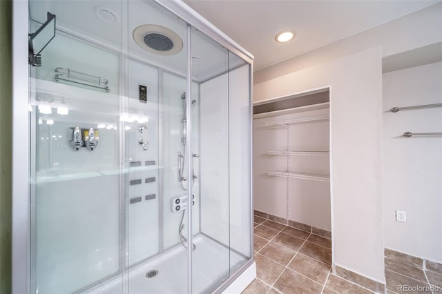 bathroom featuring tile patterned flooring and a shower with shower door