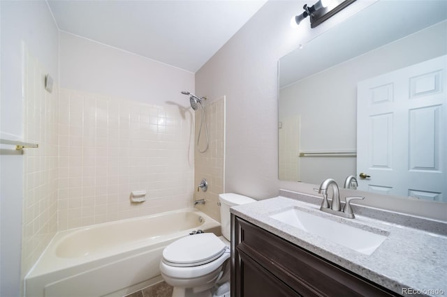 full bathroom with tiled shower / bath, vanity, and toilet