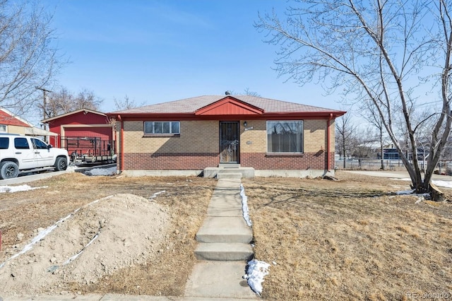 bungalow-style home with brick siding and an attached garage