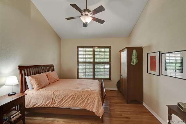 bedroom featuring high vaulted ceiling, a ceiling fan, baseboards, and wood finished floors