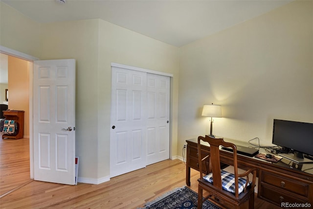 office space featuring light wood-type flooring and baseboards