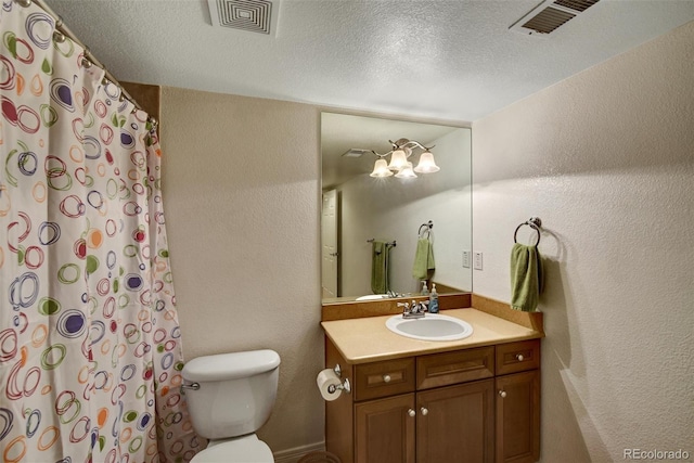 bathroom featuring toilet, a textured wall, vanity, and visible vents