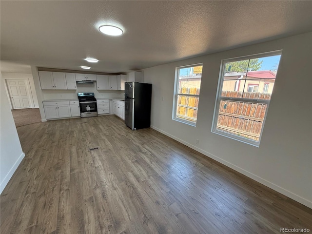 9036 Mandel St, Denver, CO 80260 - kitchen featuring freestanding refrigerator, stainless steel range with electric stovetop, wood finished floors, baseboards, and a textured ceiling