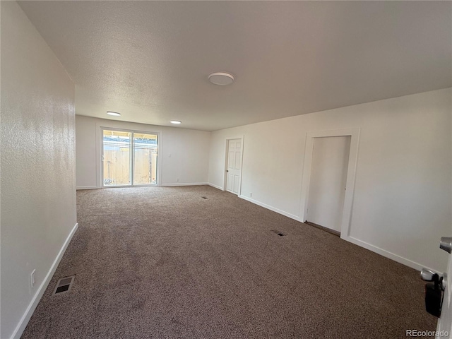 9036 Mandel St, Denver, CO 80260 - empty room with baseboards, carpet flooring, and a textured ceiling