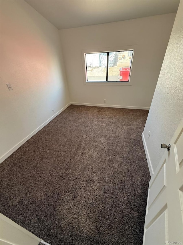 9036 Mandel St, Denver, CO 80260 - empty room featuring baseboards and dark carpet