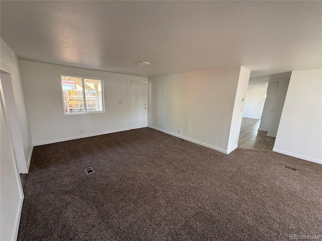 9036 Mandel St, Denver, CO 80260 - unfurnished room with a textured ceiling, dark colored carpet, and baseboards