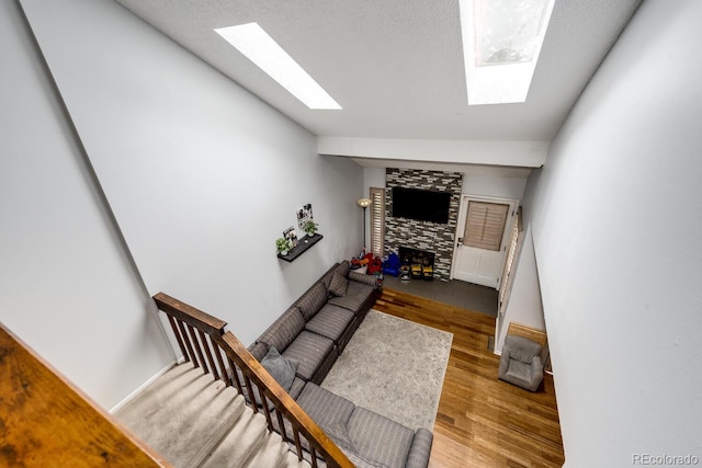 4356 S Blackhawk Way, Aurora, CO 80015 - staircase with a skylight, a fireplace, wood finished floors, and vaulted ceiling