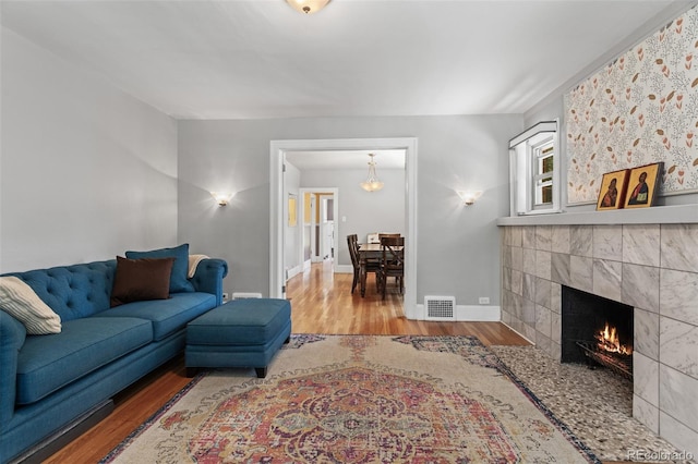 living room with hardwood / wood-style floors and a tile fireplace