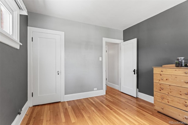 unfurnished bedroom with light wood-type flooring