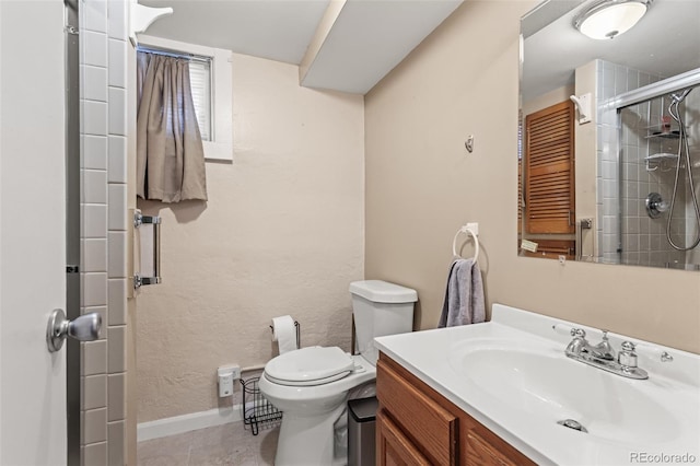 bathroom featuring tile patterned floors, a shower with shower door, toilet, and vanity