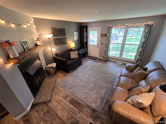 14232 E Hawaii Cir Unit A, Aurora, CO 80012 - living area featuring a textured ceiling and wood finished floors