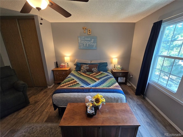 14232 E Hawaii Cir Unit A, Aurora, CO 80012 - bedroom featuring wood finished floors, multiple windows, a textured ceiling, and a ceiling fan
