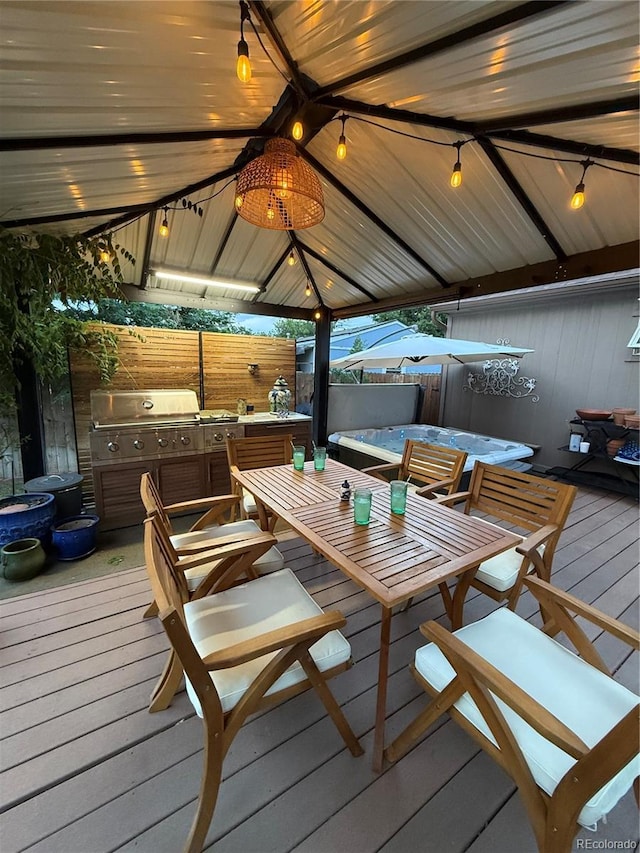 16796 E Union Ave, Aurora, CO 80015 - deck featuring a gazebo, a hot tub, and outdoor dining area