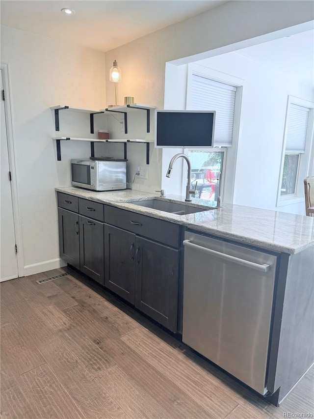16796 E Union Ave, Aurora, CO 80015 - kitchen with dishwasher, light stone counters, open shelves, a peninsula, and recessed lighting