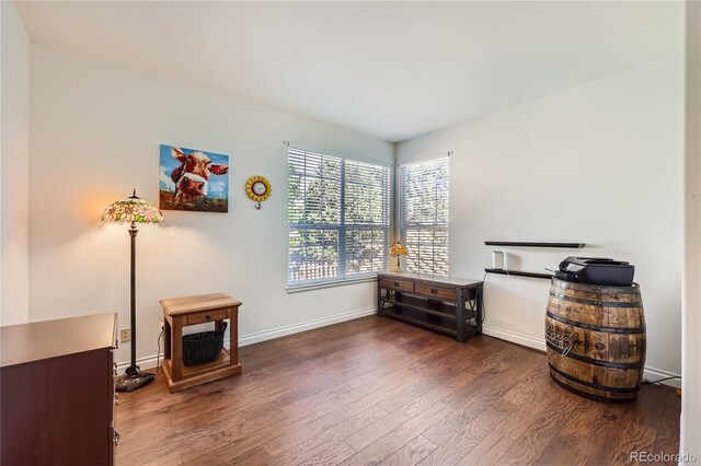 living area featuring baseboards and wood finished floors