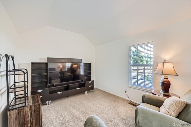 carpeted living area featuring baseboards, visible vents, and vaulted ceiling