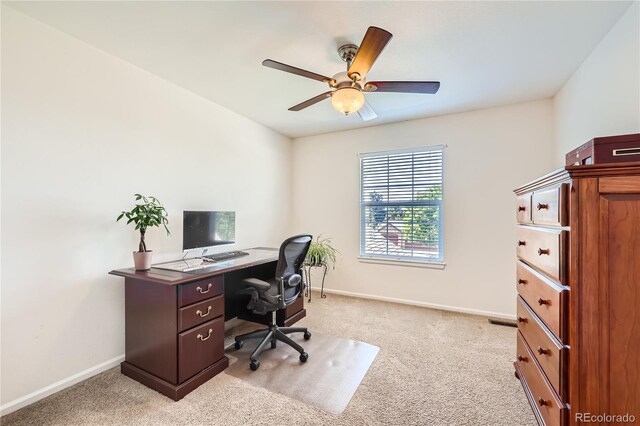 office with a ceiling fan, light carpet, and baseboards