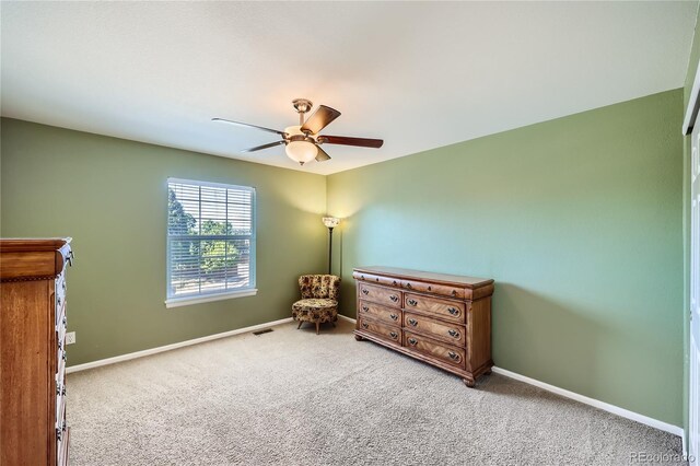 carpeted bedroom featuring visible vents, a ceiling fan, and baseboards