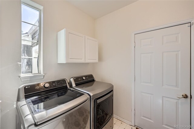 laundry room with washing machine and dryer and cabinet space