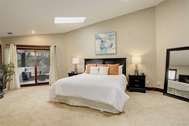 bedroom featuring visible vents, access to exterior, baseboards, vaulted ceiling with skylight, and carpet