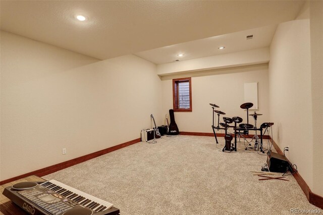 workout area with baseboards, visible vents, and carpet