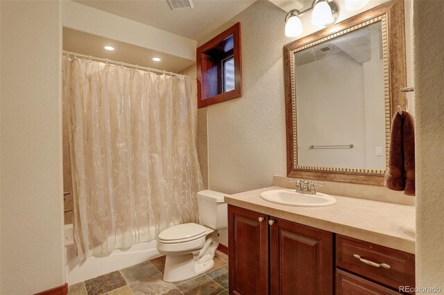 bathroom with toilet, a textured wall, shower / bath combination with curtain, and vanity