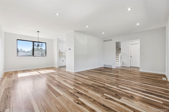 7351 S Marion St, Centennial, CO 80122 - unfurnished room featuring stairway, light wood-style flooring, a chandelier, and recessed lighting