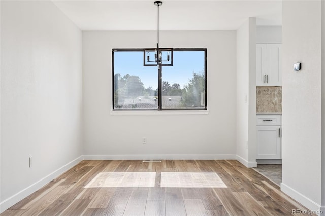 7351 S Marion St, Centennial, CO 80122 - unfurnished dining area featuring a chandelier and light wood finished floors