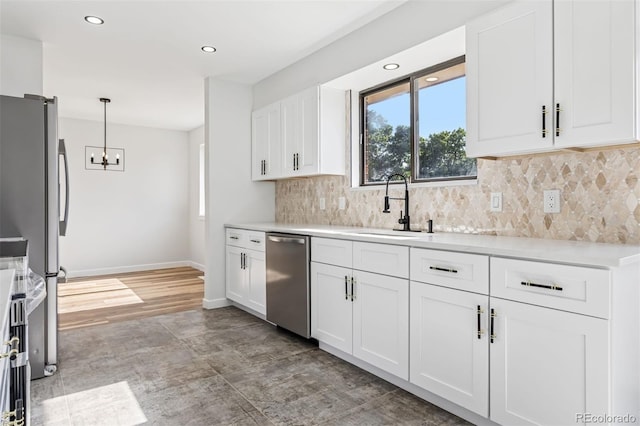 7351 S Marion St, Centennial, CO 80122 - kitchen with stainless steel appliances, a chandelier, white cabinets, decorative backsplash, and light countertops