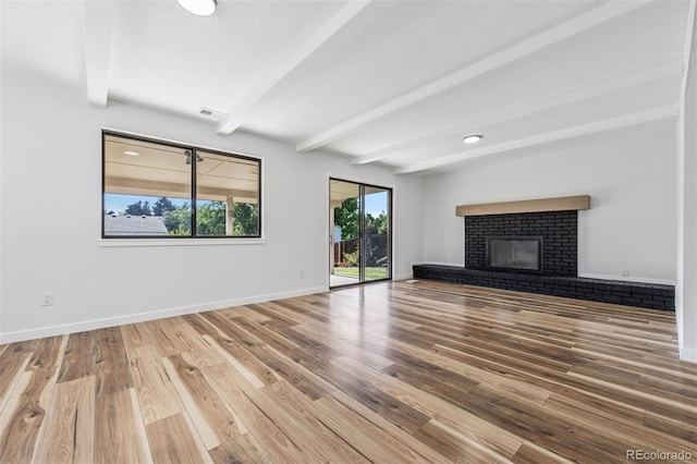 7351 S Marion St, Centennial, CO 80122 - unfurnished living room with beam ceiling, wood finished floors, and a fireplace