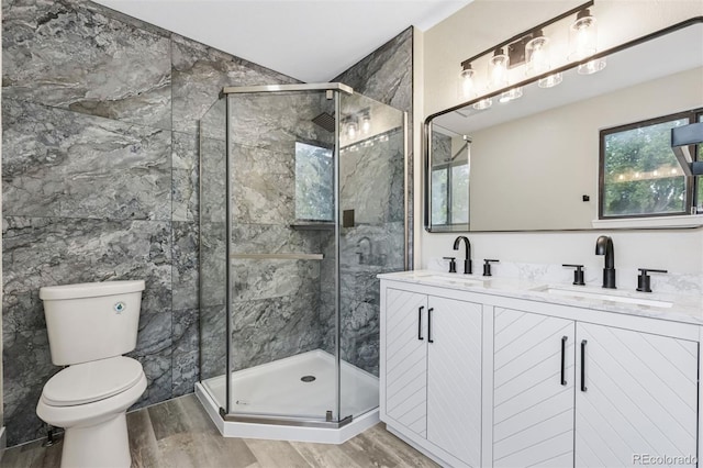 7351 S Marion St, Centennial, CO 80122 - full bath featuring wood finished floors, double vanity, and a stall shower