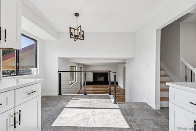 7351 S Marion St, Centennial, CO 80122 - unfurnished living room featuring stairs and a chandelier