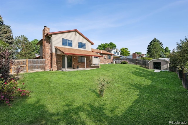 7351 S Marion St, Centennial, CO 80122 - rear view of house with a chimney, a fenced backyard, a patio area, and brick siding