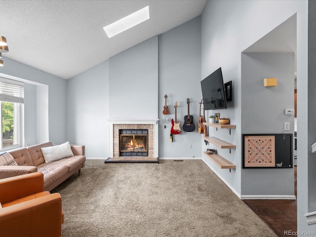 966 Cherry Blossom Ct, Highlands Ranch, CO 80126 - living room with a glass covered fireplace, high vaulted ceiling, a skylight, carpet, and a textured ceiling