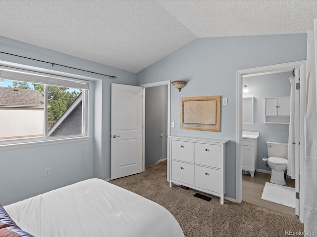 966 Cherry Blossom Ct, Highlands Ranch, CO 80126 - bedroom featuring vaulted ceiling, carpet, a textured ceiling, and ensuite bathroom