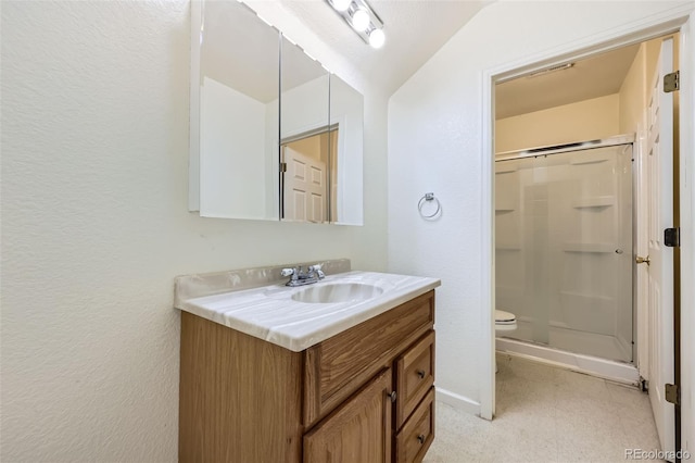 1730 Pear Ct, Brighton, CO 80601 - bathroom featuring vanity, a stall shower, a textured wall, and vaulted ceiling