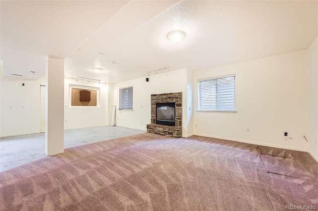 1730 Pear Ct, Brighton, CO 80601 - unfurnished living room featuring track lighting, carpet flooring, and a fireplace