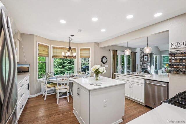 775 Poppywood Dr, Highlands Ranch, CO 80126 - kitchen featuring stainless steel appliances, a chandelier, white cabinets, a kitchen island, and recessed lighting