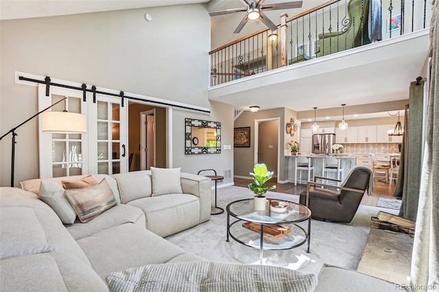 775 Poppywood Dr, Highlands Ranch, CO 80126 - living room with a high ceiling, a ceiling fan, and a barn door