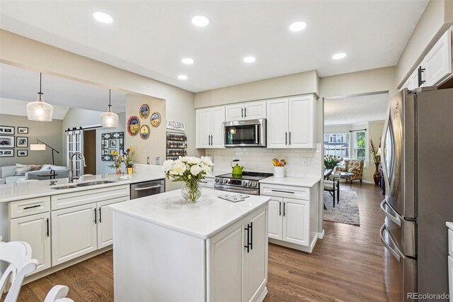 775 Poppywood Dr, Highlands Ranch, CO 80126 - kitchen with stainless steel appliances, white cabinetry, dark wood finished floors, light countertops, and recessed lighting