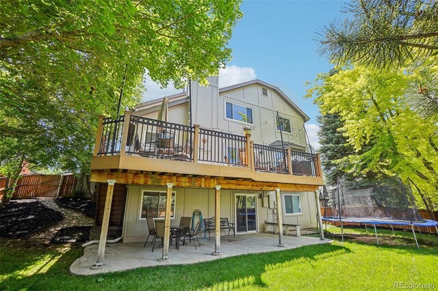 775 Poppywood Dr, Highlands Ranch, CO 80126 - rear view of property with a trampoline, a patio area, and a deck