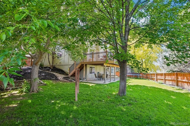 775 Poppywood Dr, Highlands Ranch, CO 80126 - fenced backyard with a wooden deck, a patio area, stairway, and a trampoline