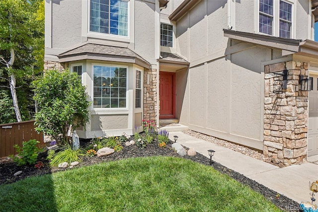 775 Poppywood Dr, Highlands Ranch, CO 80126 - view of exterior entry with stucco siding, stone siding, and a garage
