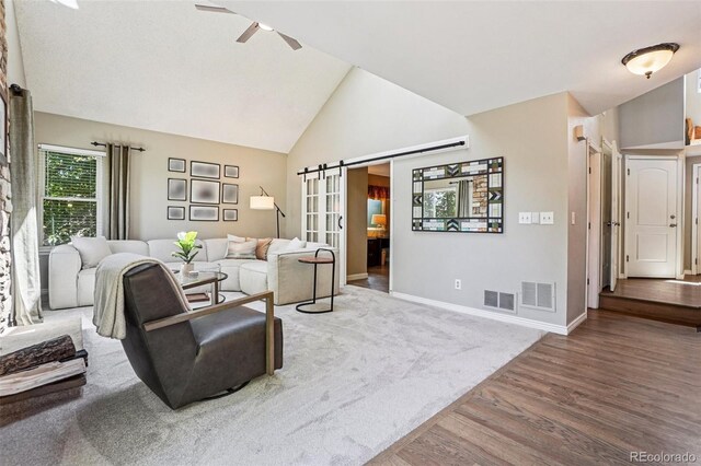 775 Poppywood Dr, Highlands Ranch, CO 80126 - living area featuring wood finished floors, ceiling fan, a barn door, and high vaulted ceiling