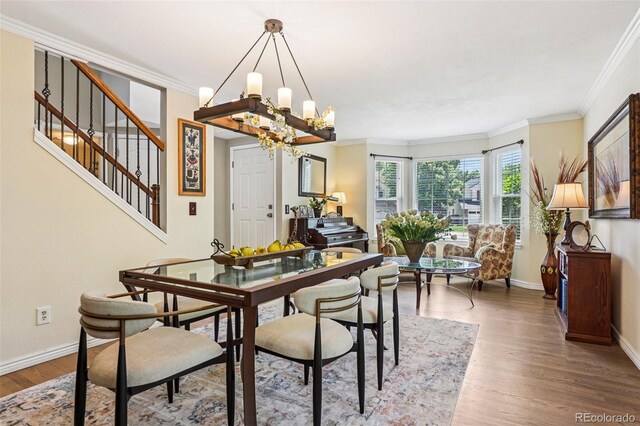 775 Poppywood Dr, Highlands Ranch, CO 80126 - dining area featuring a chandelier, ornamental molding, wood finished floors, and stairway